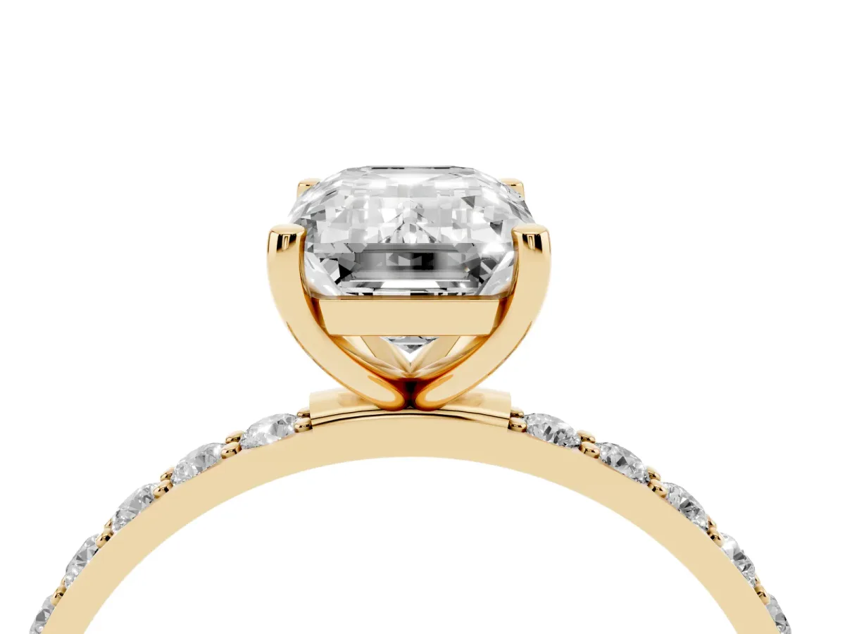 Emerald Cut Diamond Solitaire Ring with Round Pavé Shoulders and Prong Setting Yellow gold