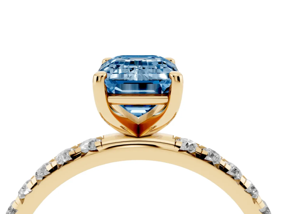 Fancy Blue Emerald Cut Cut Diamond Solitaire Ring with Micro Pave Band and Four Prong Setting Yellow gold