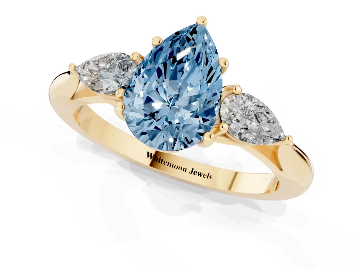 Fancy Blue Pear Cut Diamond Three-Stone Ring with Pear Side Stones and Prong Setting Yellow gold