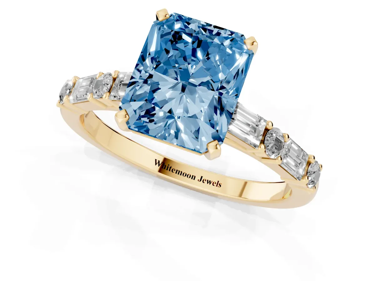 Fancy Blue Radiant Cut Diamond Solitaire with Side Baguettes and Channel Set Band Yellow gold