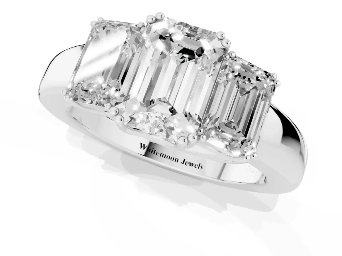 Three-Stone Emerald Cut Cut Diamond Ring with Channel Set Band and Four-Prong Setting Platinum