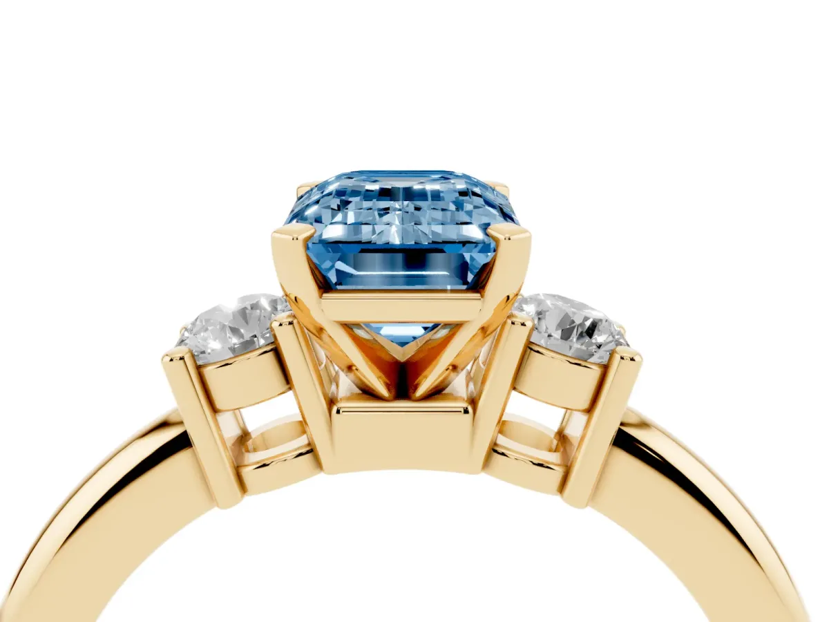 Fancy Blue Three-Stone Emerald Cut Cut Diamond Solitaire with Prong Setting and Classic Band Yellow gold