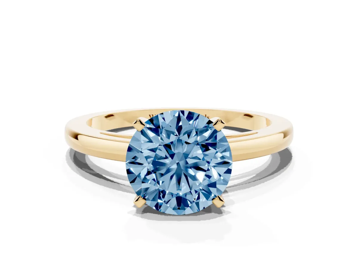Fancy Blue Round Cut Solitaire Diamond Engagement Ring with Four-Prong Setting on a Classic Band Yellow gold