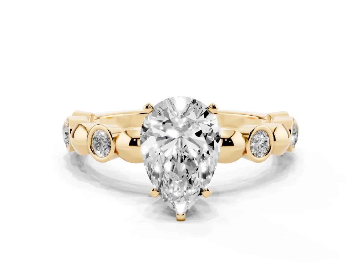Pear Cut Solitaire Bezel-Set Diamond Ring with Beaded Band and Four-Prong Setting Yellow gold