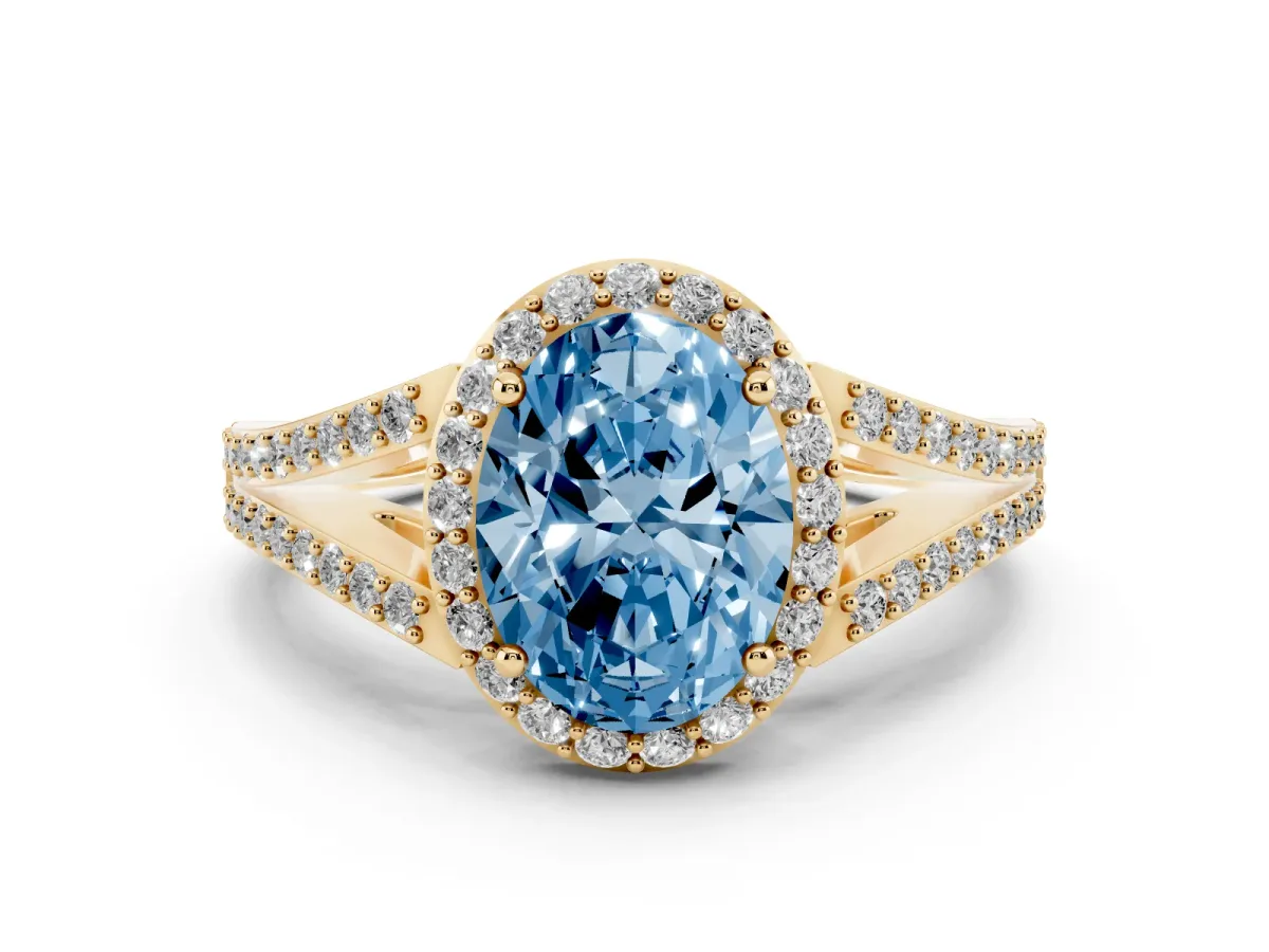 Fancy Blue Oval Cut Halo Split Shank Pave Diamond Ring with Four-Prong Setting Yellow gold