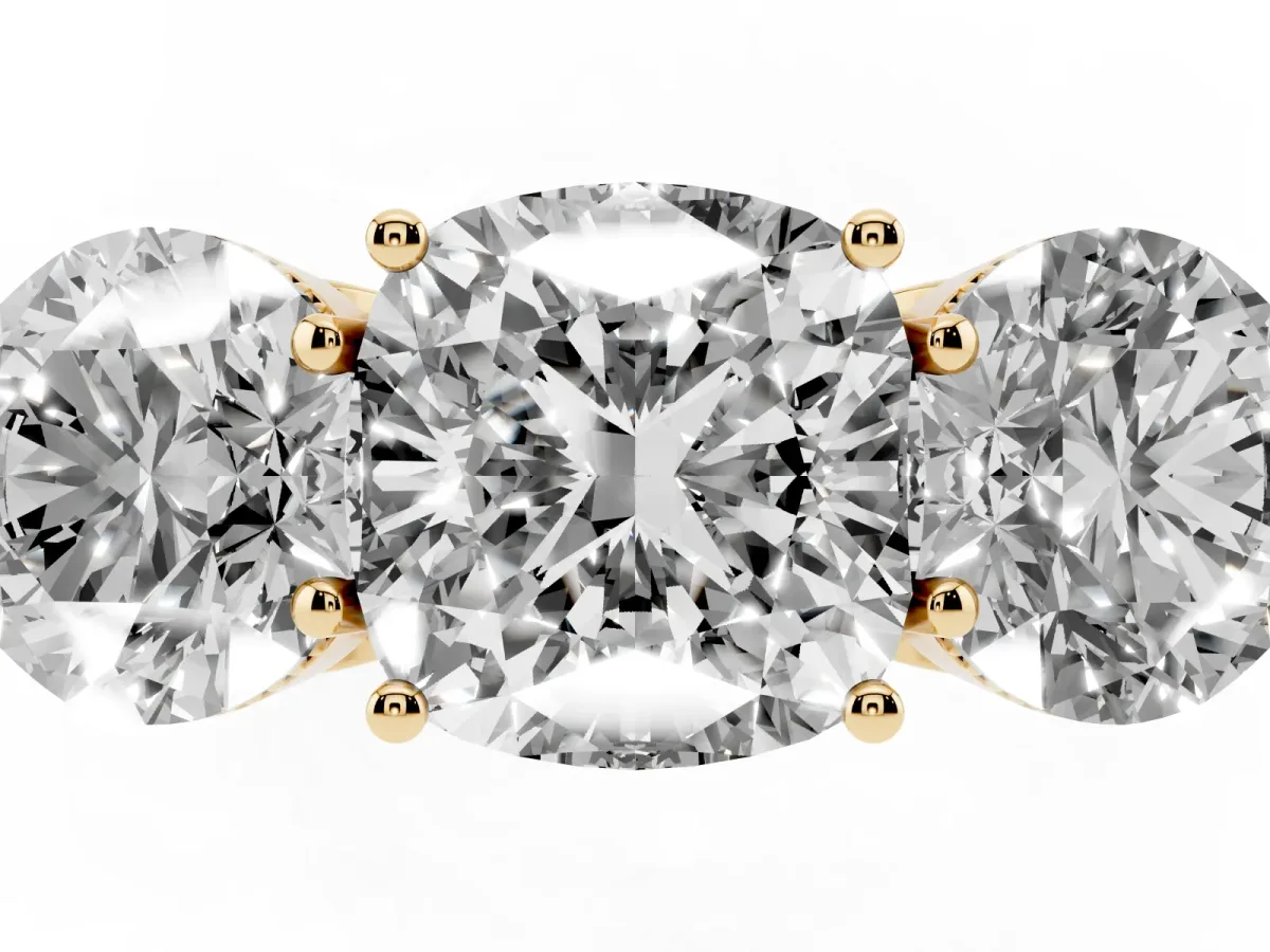 Three-Stone Cushion Cut Diamond Engagement Ring with Prong Setting on a Classic Band Yellow gold