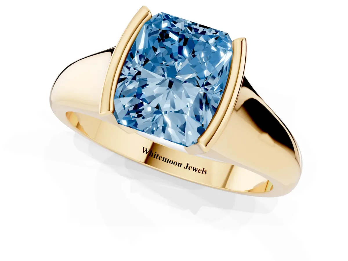 Fancy Blue Radiant Cut Solitaire Tension Set Diamond Ring with Split Shank Band Yellow gold