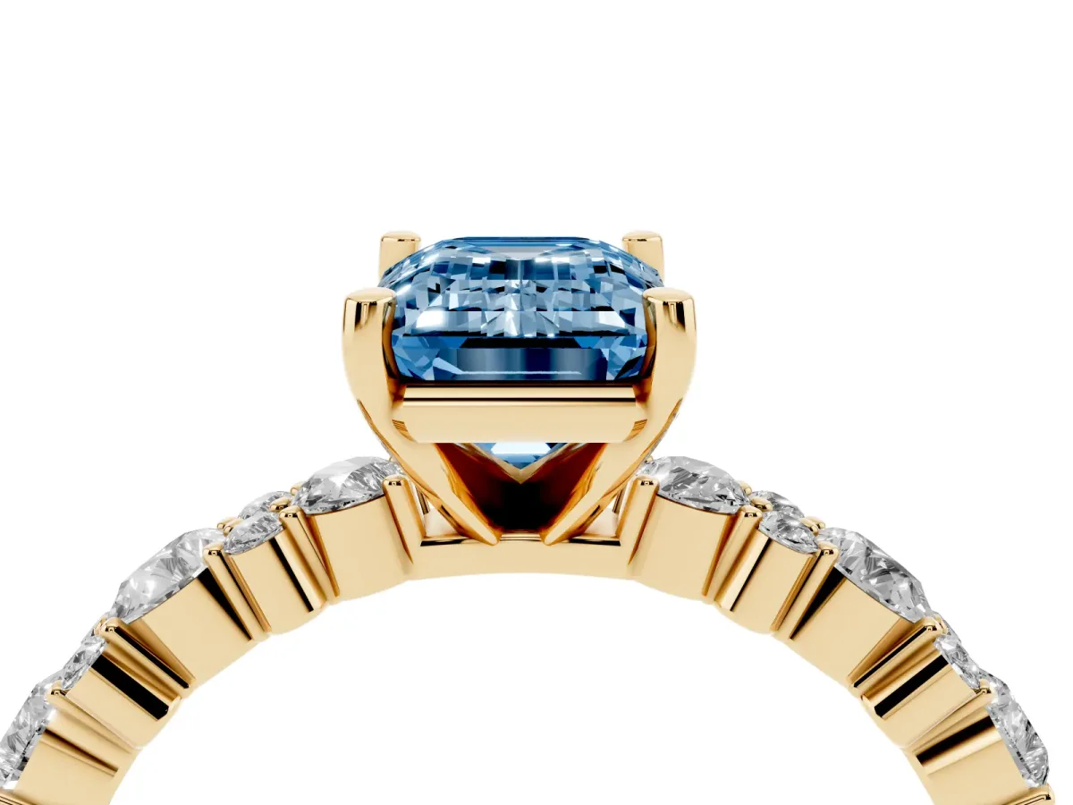 Fancy Blue Emerald Cut Diamond Side Stone Solitaire Ring with Round and Four-Prong Setting Yellow gold