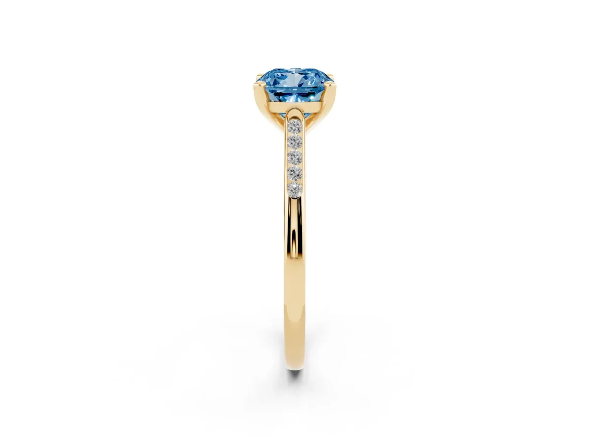 Fancy Blue Cushion Cut Diamond Solitaire Ring with Channel Set Round Band and Prong Setting Yellow gold