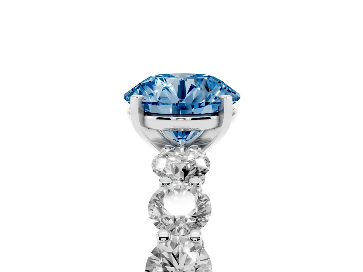 Fancy Blue Round Cut Diamond Prong Setting with Side Stones on a Pave Band Silver
