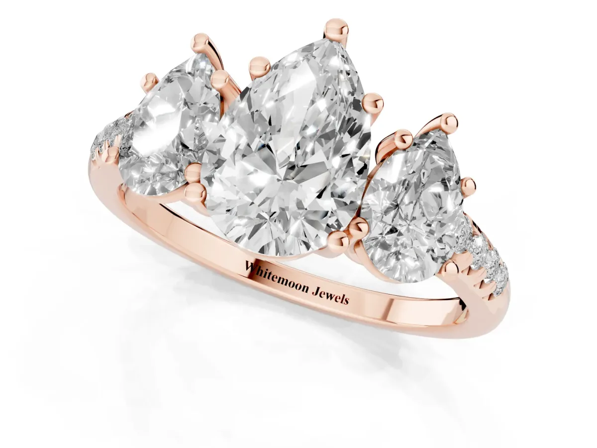 Three-Stone Pear Cut Diamond Ring with Round Pavé Band and Prong Setting Rose gold