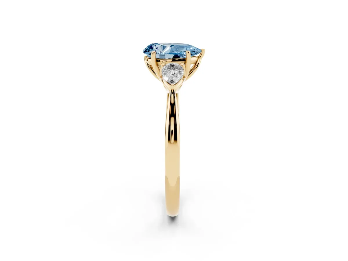 Fancy Blue Three-Stone Pear Cut Brilliant Diamond Solitaire Ring with Tapered Band and Four-Prong Setting Yellow gold