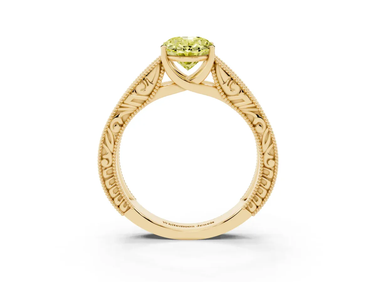 Fancy Yellow Oval Cut Diamond Solitaire Ring with Engraved Band and Four-Prong Setting Yellow gold