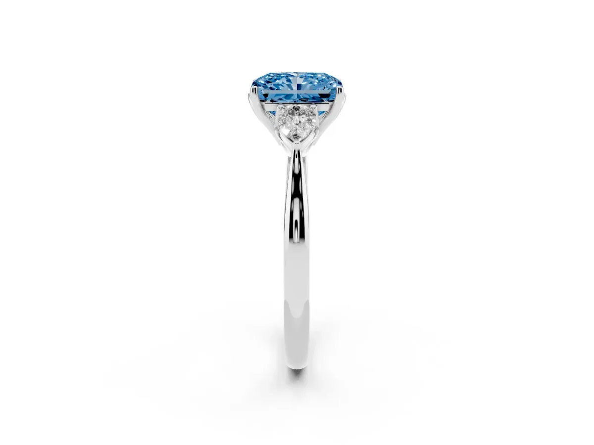Fancy Blue Three-Stone Radiant Cut Diamond Ring with Pear Side Stones in Four-Prong Setting Platinum
