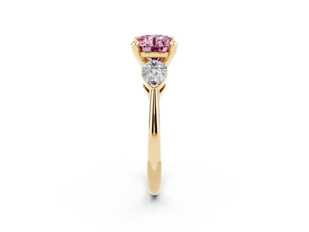 Fancy Pink Three-Stone Round Cut Diamond Ring with Pear Side Stones and Four-Prong Setting Yellow gold