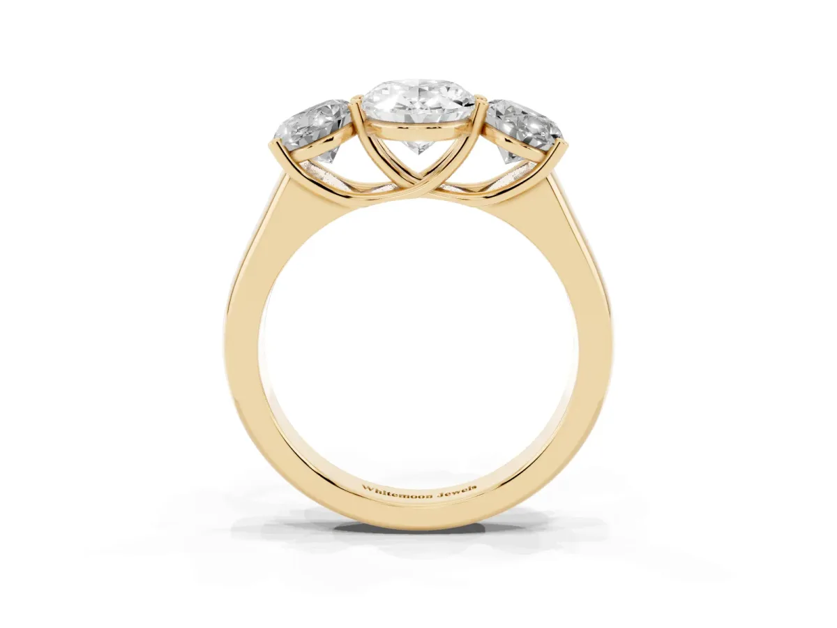 Oval Cut Three-Stone Diamond Ring with Prong Setting on a Classic Band Yellow gold