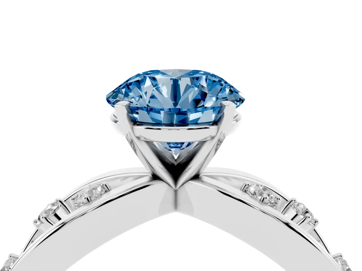 Fancy Blue Round Cut Cut Solitaire Diamond with Side Stones on Criss-Cross Band and Four-Prong Setting Silver