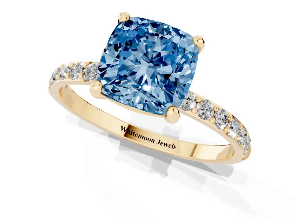 Fancy Blue Cushion Cut Diamond Solitaire Ring with Round Pavé Band and Prong Setting Yellow gold