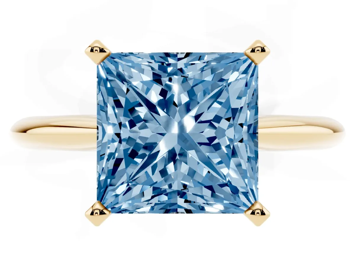 Fancy Blue Princess Cut Cut Solitaire Ring with Four-Prong Setting on a Classic Band Yellow gold