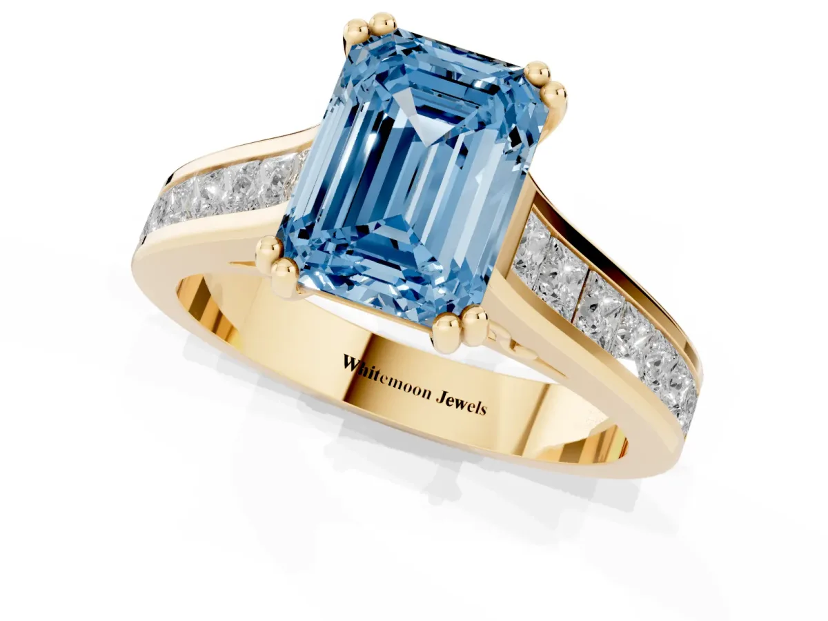 Fancy Blue Emerald Cut Cut Channel Set Solitaire Engagement Ring with Prong Setting Yellow gold
