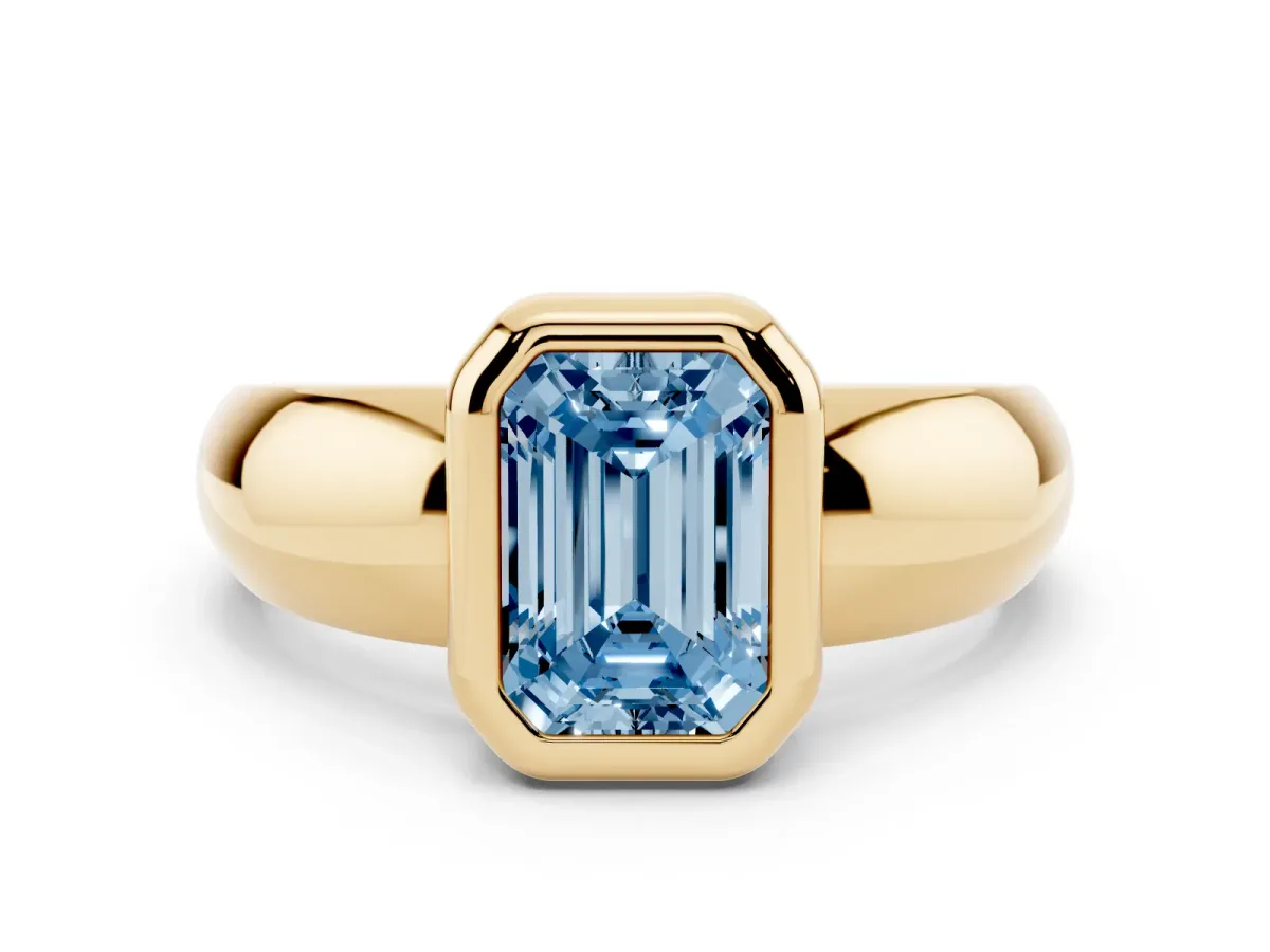Fancy Blue Bezel Set Emerald Cut Solitaire Ring with Wide Band Yellow gold