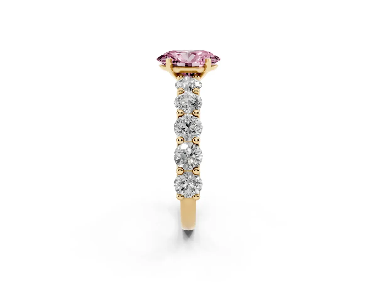 Fancy Pink Oval Cut Diamond Prong Setting with Side Stones on a Pave Band Yellow gold