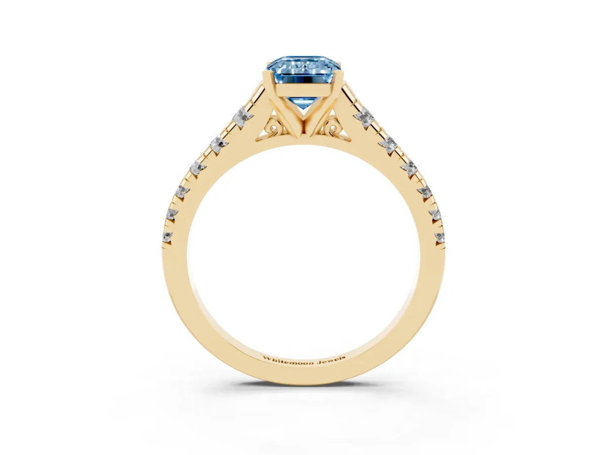 Fancy Blue Emerald Cut Diamond Cathedral Solitaire Ring with Round Pavé Band Yellow gold