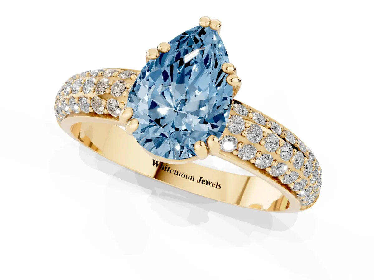 Fancy Blue Pear Cut Diamond Solitaire Ring with Multi-Row Round Pavé Band and Prong Setting Yellow gold
