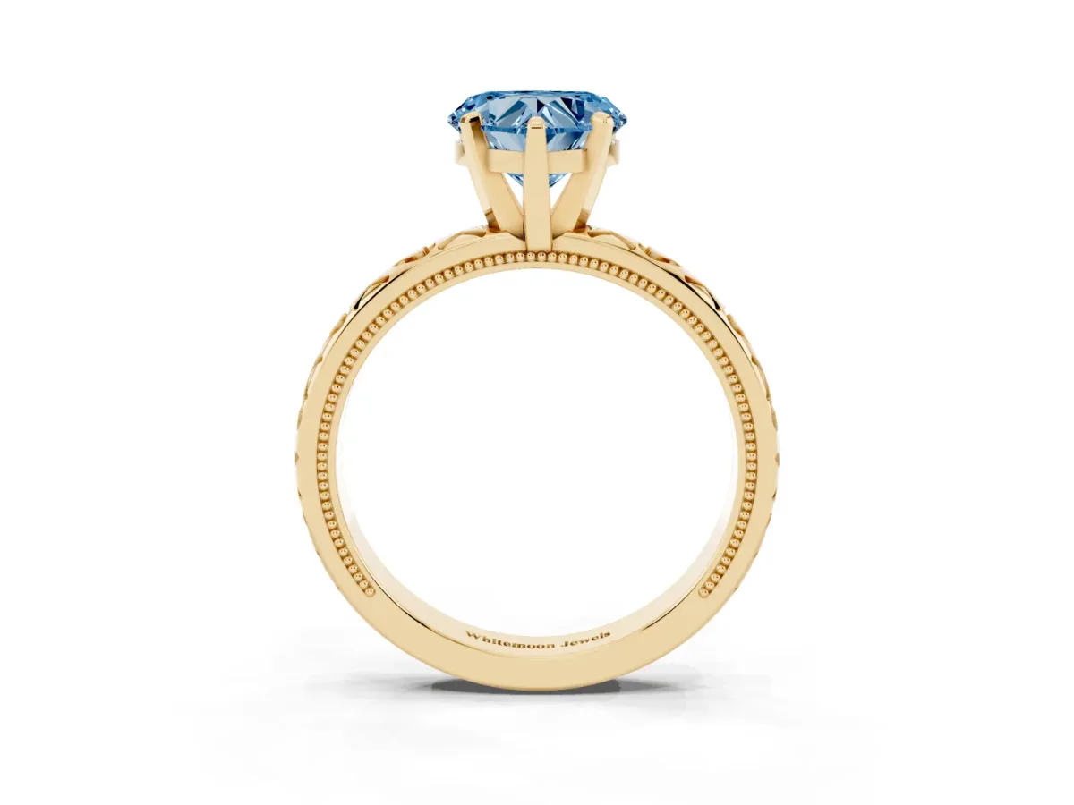 Fancy Blue Heart Cut Solitaire Diamond Engagement Ring with XO Engraved Band and Four-Prong Setting Yellow gold