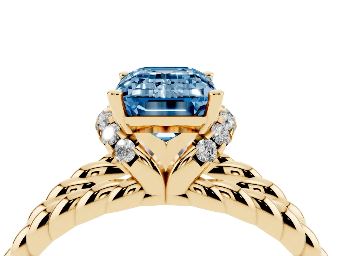 Fancy Blue Emerald Cut Halo Twisted Band Four-Prong Ring Yellow gold