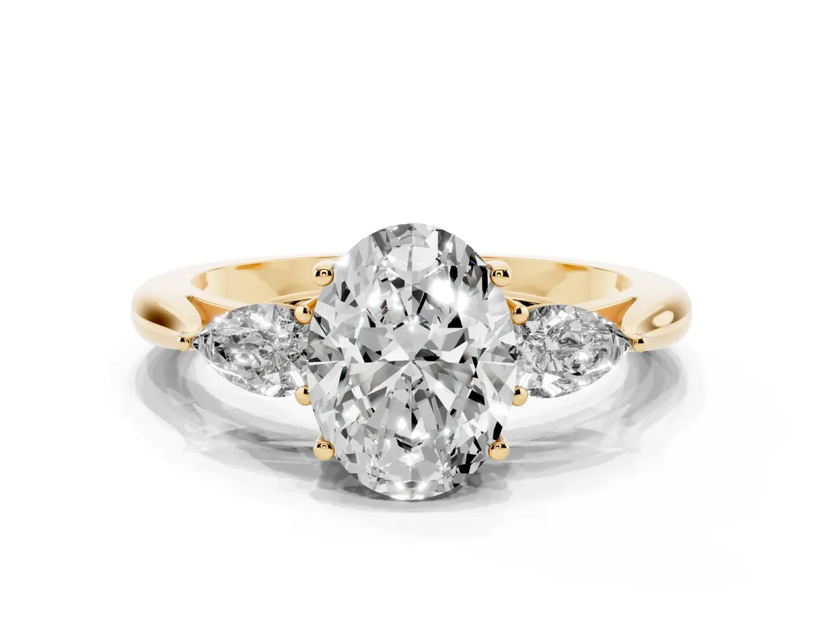 Three-Stone Oval Cut Brilliant Diamond Solitaire Ring with Tapered Band and Four-Prong Setting Yellow gold