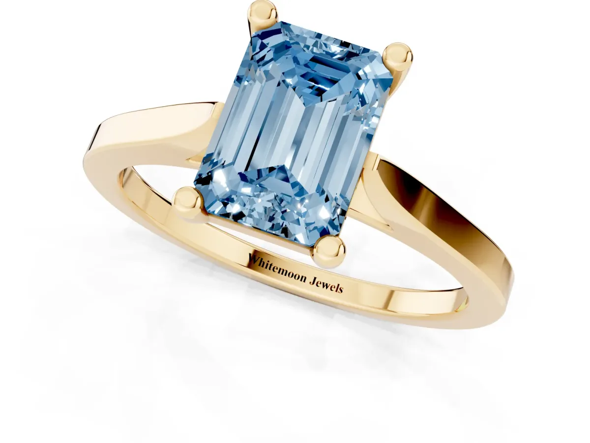 Fancy Blue Emerald Cut Solitaire Diamond Ring with Four-Prong Setting and Tapered Band Yellow gold