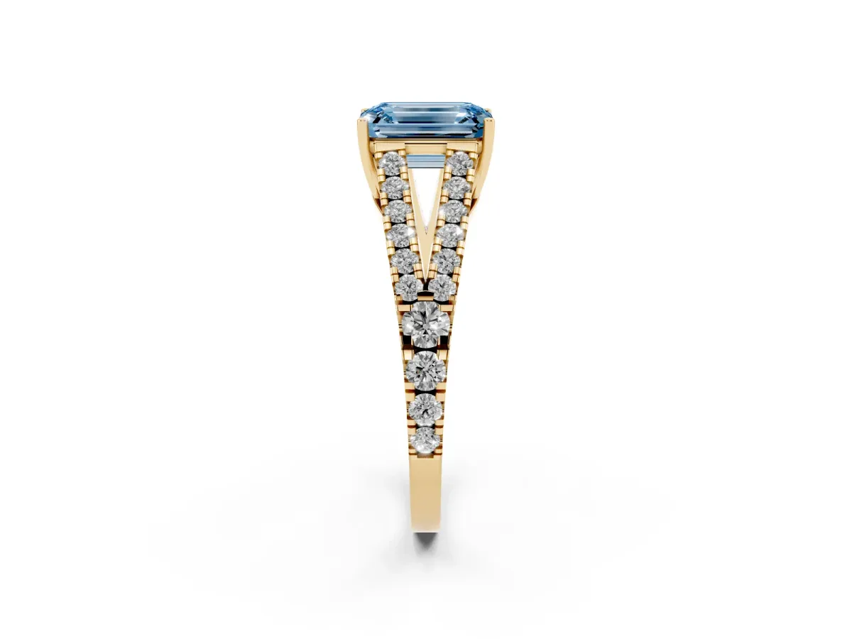 Fancy Blue Emerald Cut Diamond Split Shank Engagement Ring with Round Pavé and Prong Setting Yellow gold