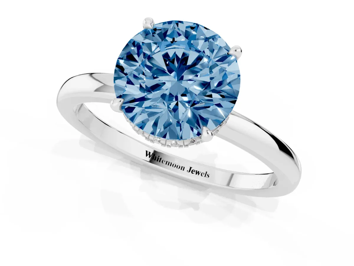 Fancy Blue Round Cut Solitaire Engagement Ring with Cathedral Band and Four-Prong Setting Silver