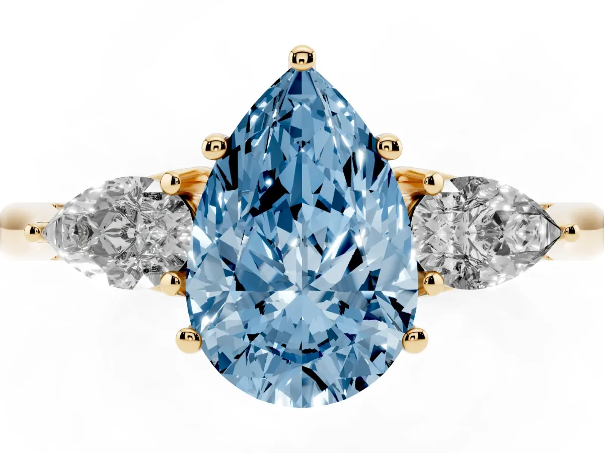 Fancy Blue Three-Stone Pear Cut Diamond Ring with Pear Side Stones in Four-Prong Setting Yellow gold