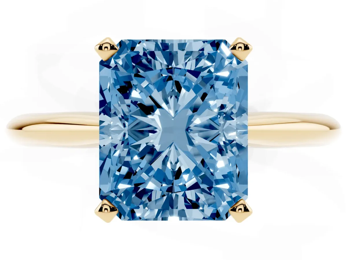 Fancy Blue Radiant Cut Cut Solitaire Ring with Four-Prong Setting on a Classic Band Yellow gold