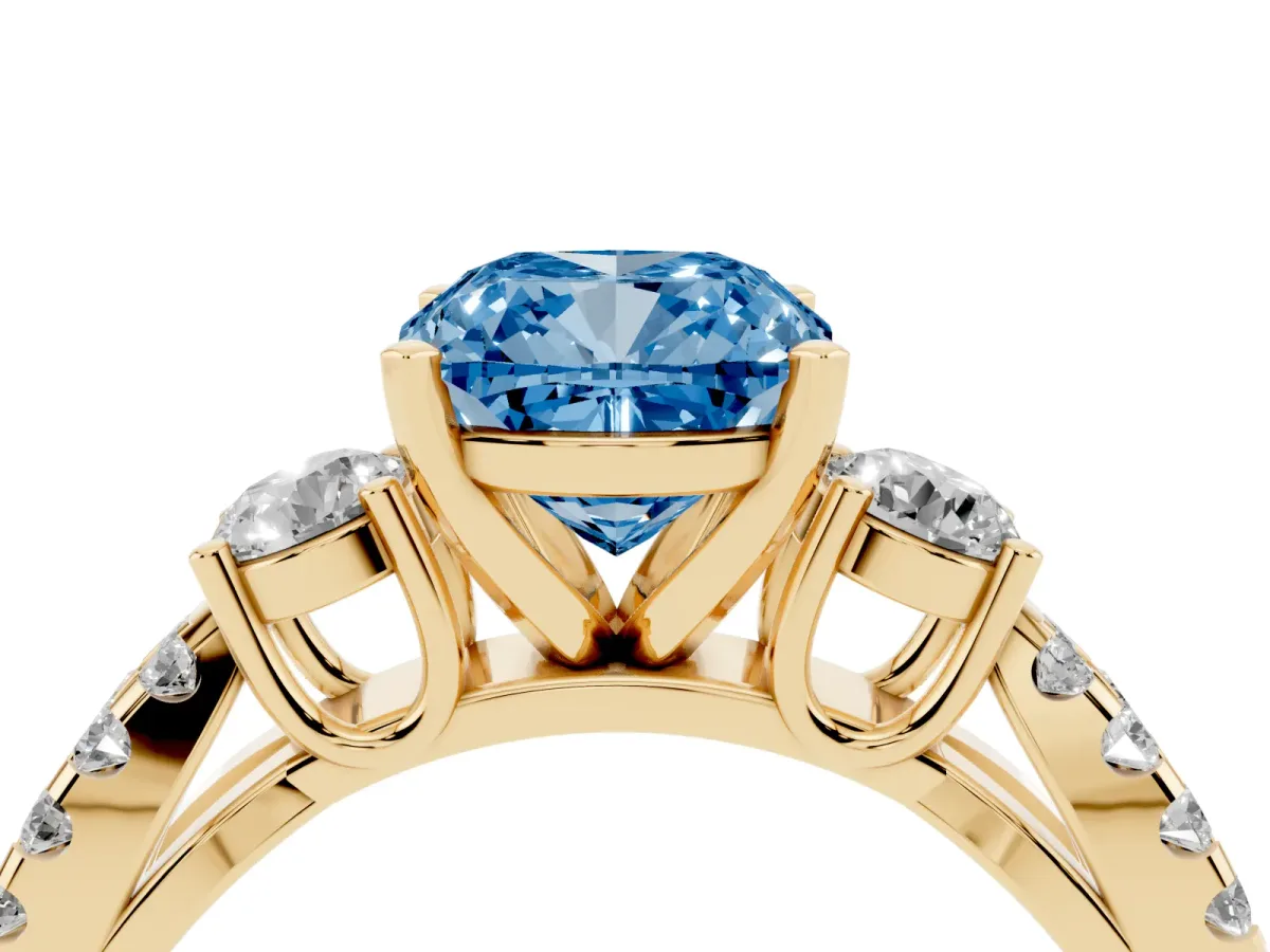 Fancy Blue Cushion Cut Diamond Three-Stone Ring with Pavé Split Shank and Four-Prong Setting Yellow gold