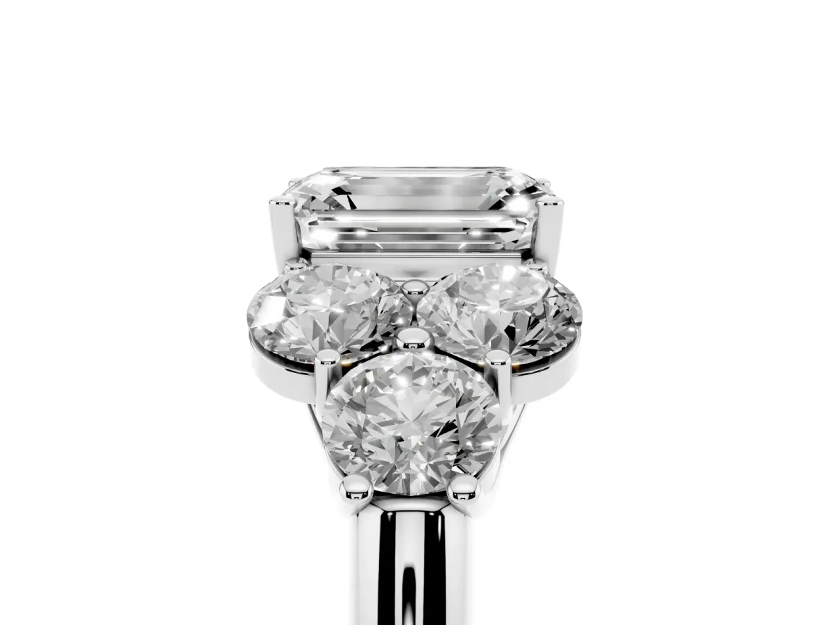 Emerald Cut Cut Diamond Cluster Ring with Round Accent Stones and Prong Setting on a Classic Band Silver