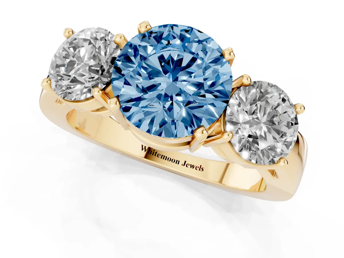 Fancy Blue Three-Stone Round Cut Diamond Ring with Round Side Stones, Classic Band, and Four-Prong Setting Yellow gold