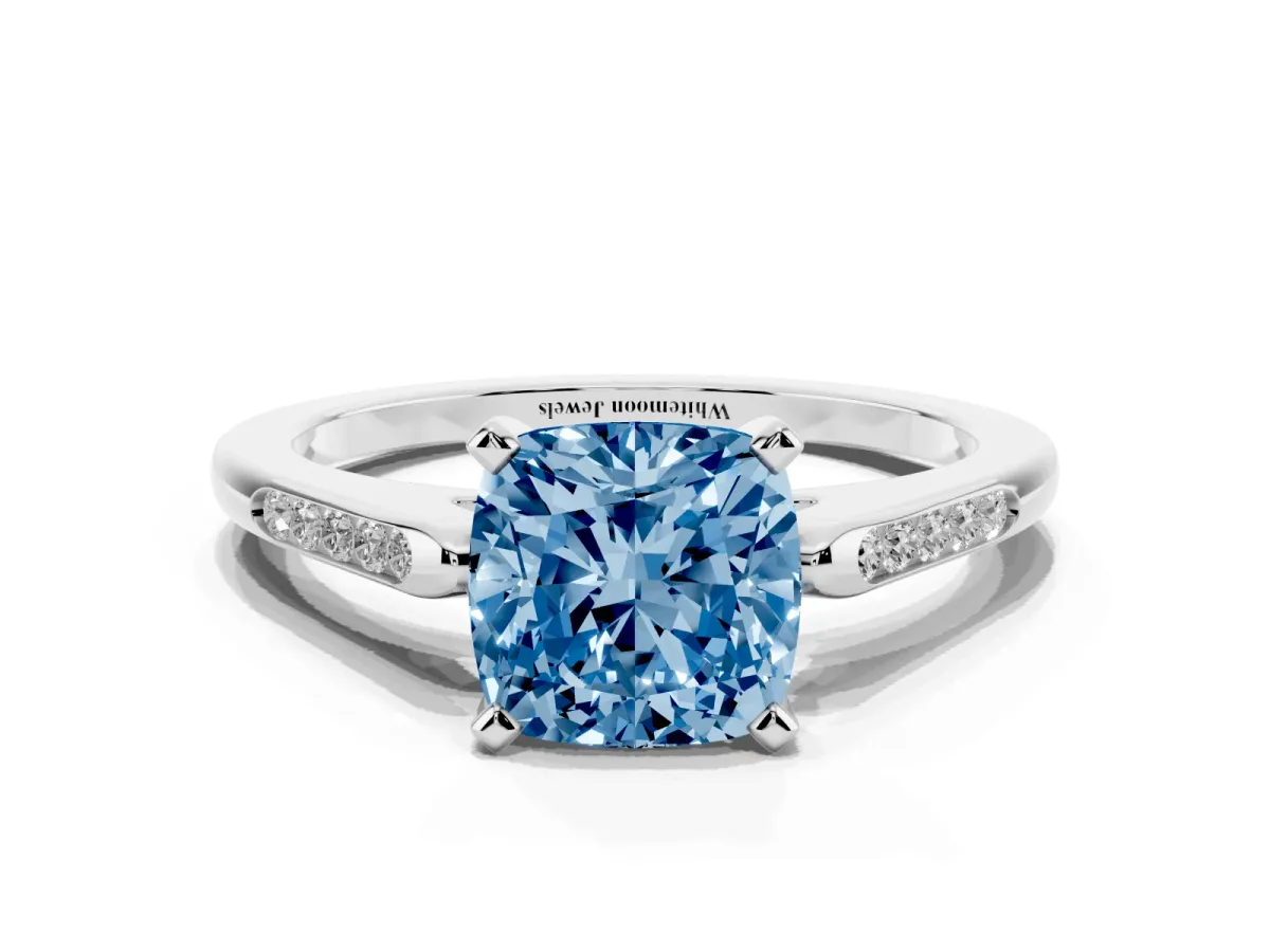 Fancy Blue Cushion Cut Diamond Solitaire Ring with Channel Set Round Band and Prong Setting Silver