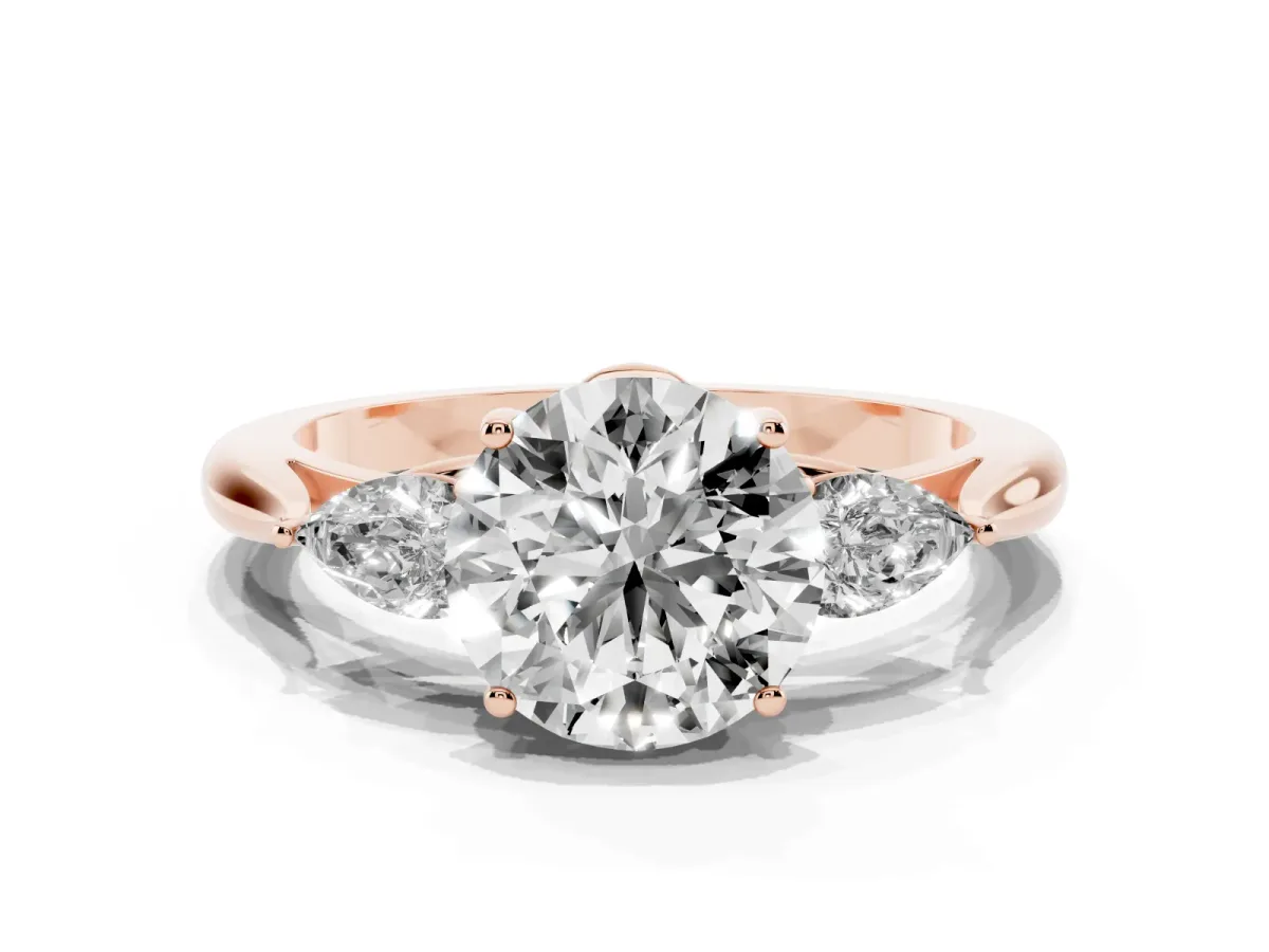 Three-Stone Round Cut Diamond Ring with Pear Side Stones in Four-Prong Setting Rose gold