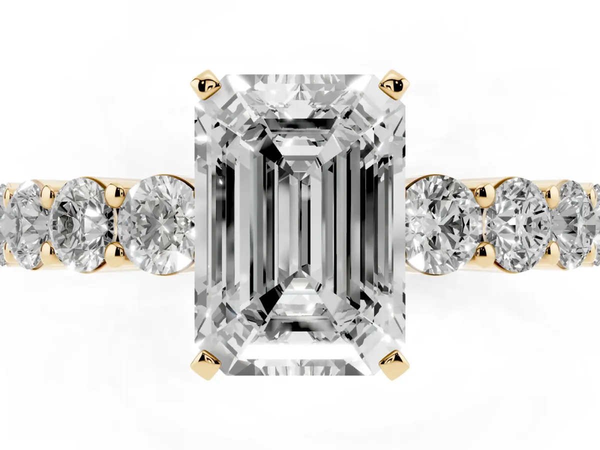 Emerald Cut Diamond Solitaire Ring with Shared Prong Round Side Stones Yellow gold
