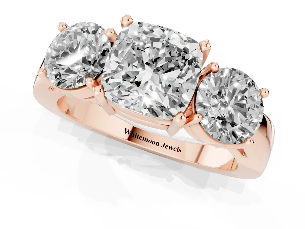 Three-Stone Cushion Cut Diamond Ring with Round Side Stones, Classic Band, and Four-Prong Setting Rose gold