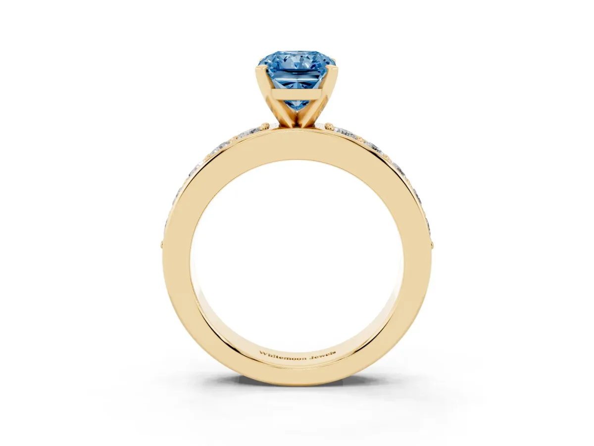 Fancy Blue Radiant Cut Diamond Engagement Ring with Channel Set Round Band and Prong Setting Yellow gold