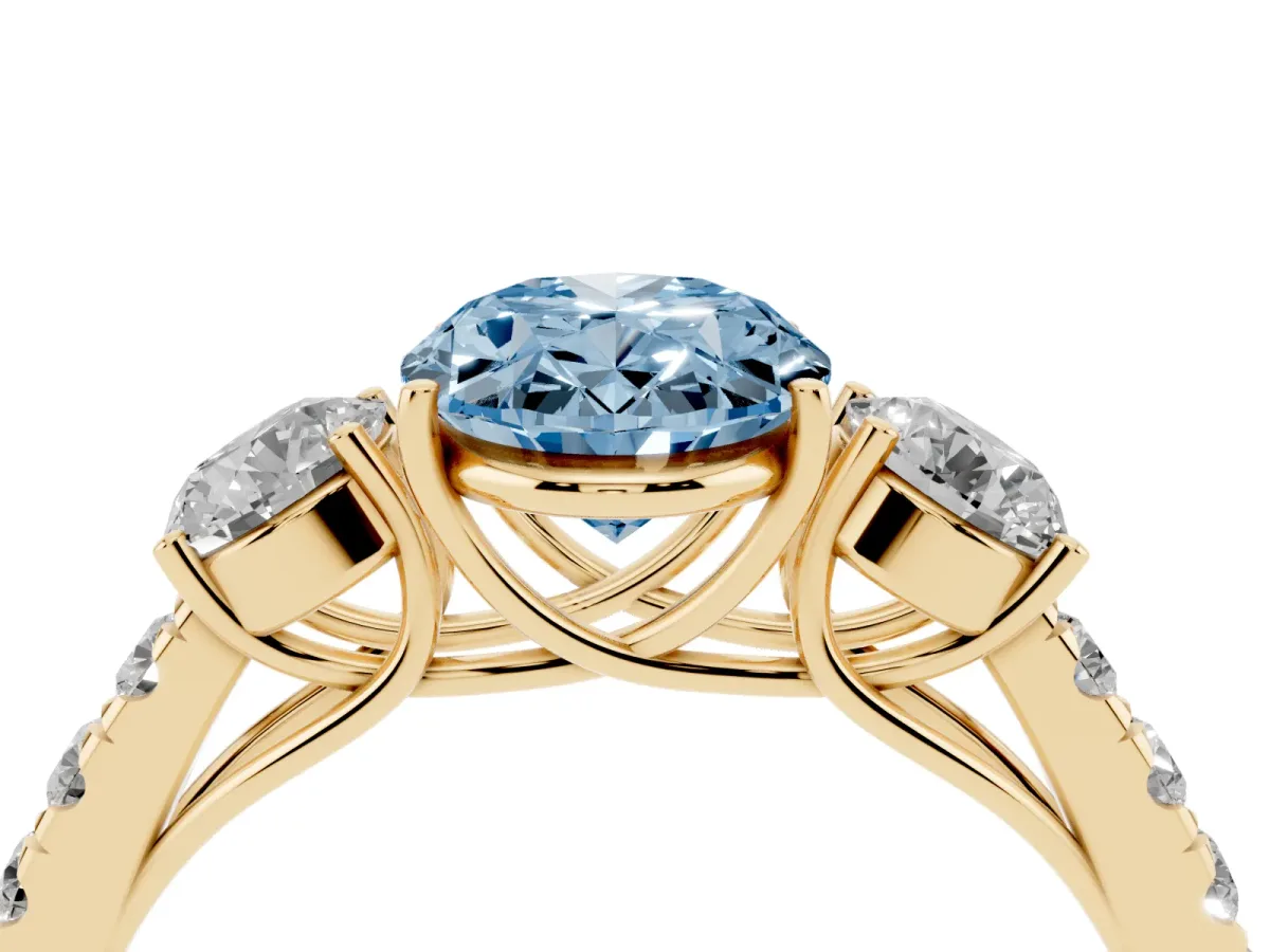 Fancy Blue Oval Cut Cut Diamond Three-Stone Ring with Round Side Stones and Pavé Band Yellow gold