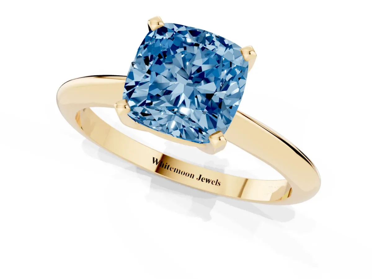 Fancy Blue Cushion Cut Cut Solitaire Ring with Four-Prong Setting on a Classic Band Yellow gold