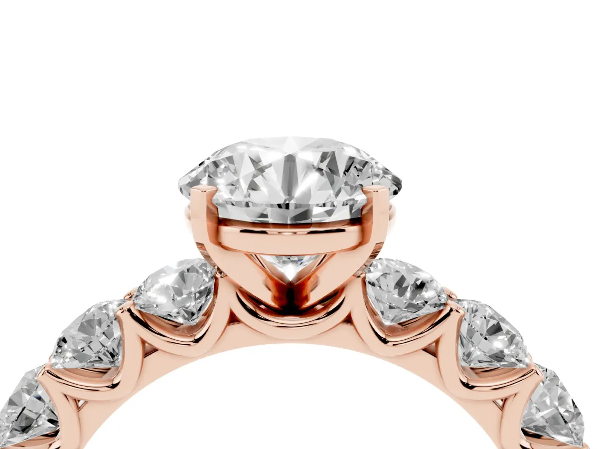 Round Cut Diamond Prong Setting with Side Stones on a Pave Band Rose gold