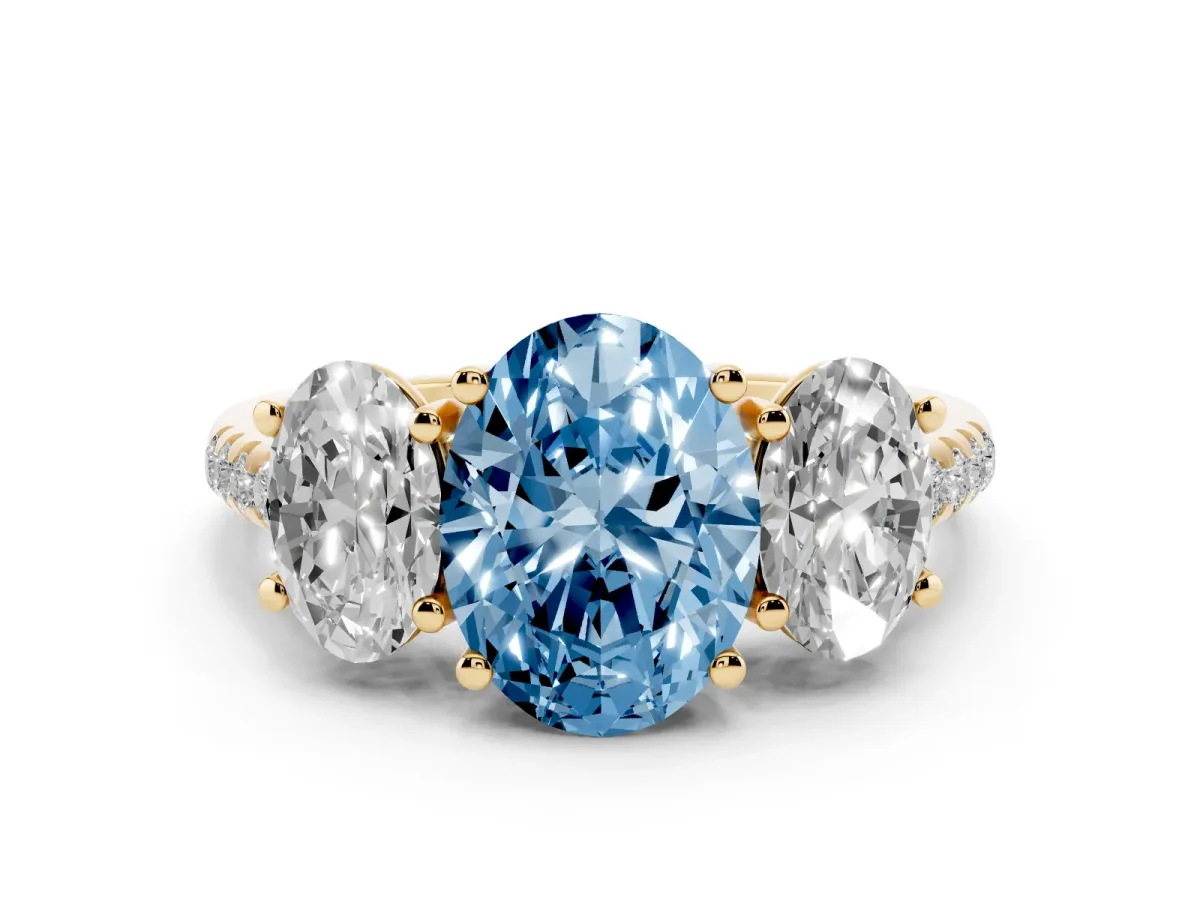 Fancy Blue Three-Stone Oval Cut Diamond Ring with Round Pavé Band and Prong Setting Yellow gold