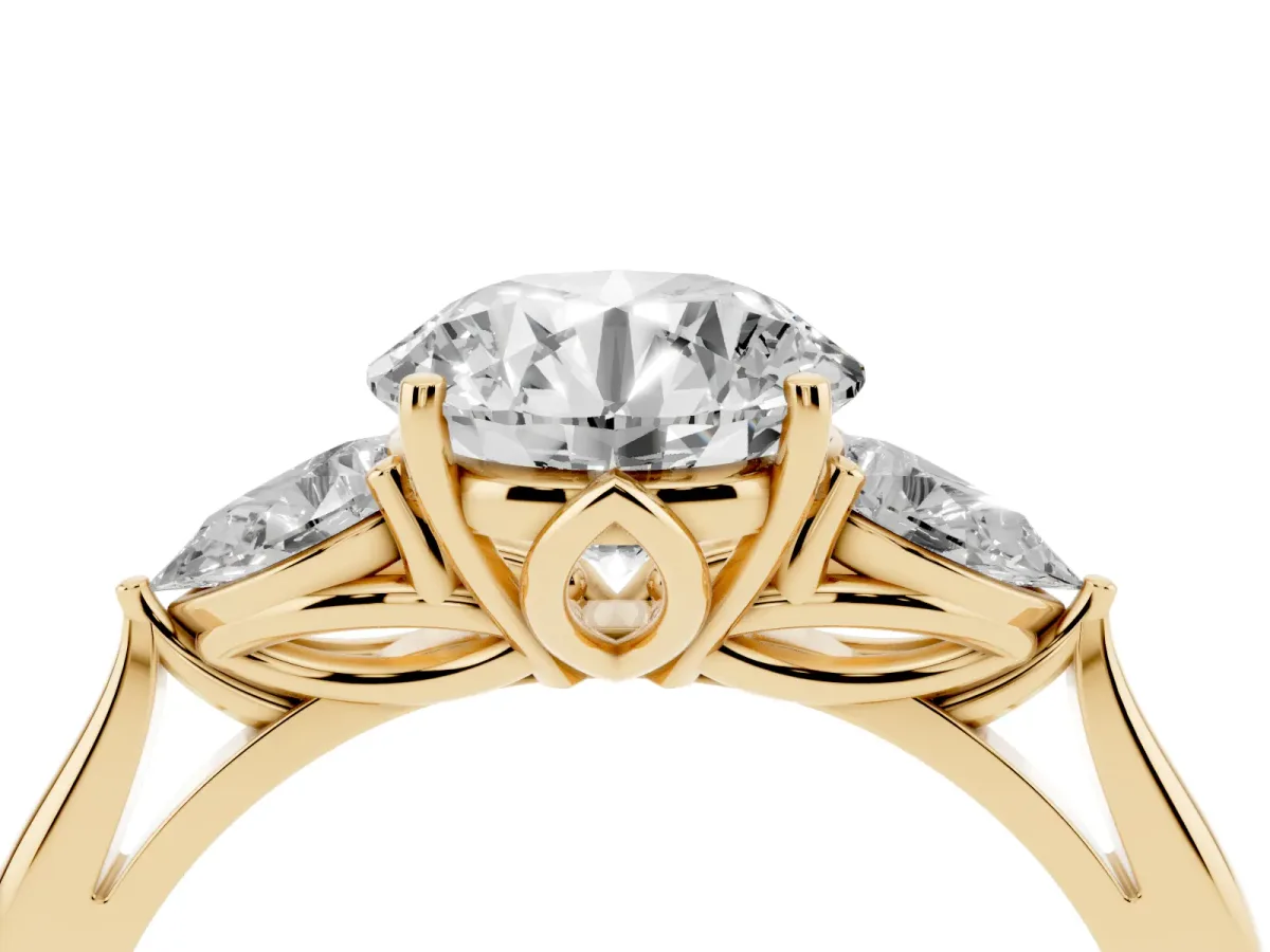 Three-Stone Round Cut Diamond Ring with Pear Side Stones in Four-Prong Setting Yellow gold