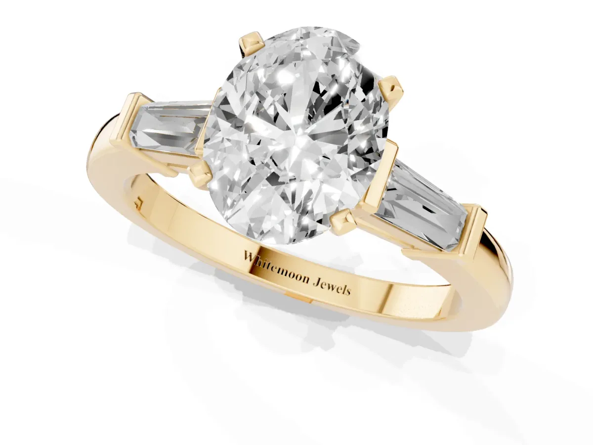 Oval Cut Cut Diamond Solitaire Ring with Tapered Baguette Accents and Four-Prong Setting Yellow gold